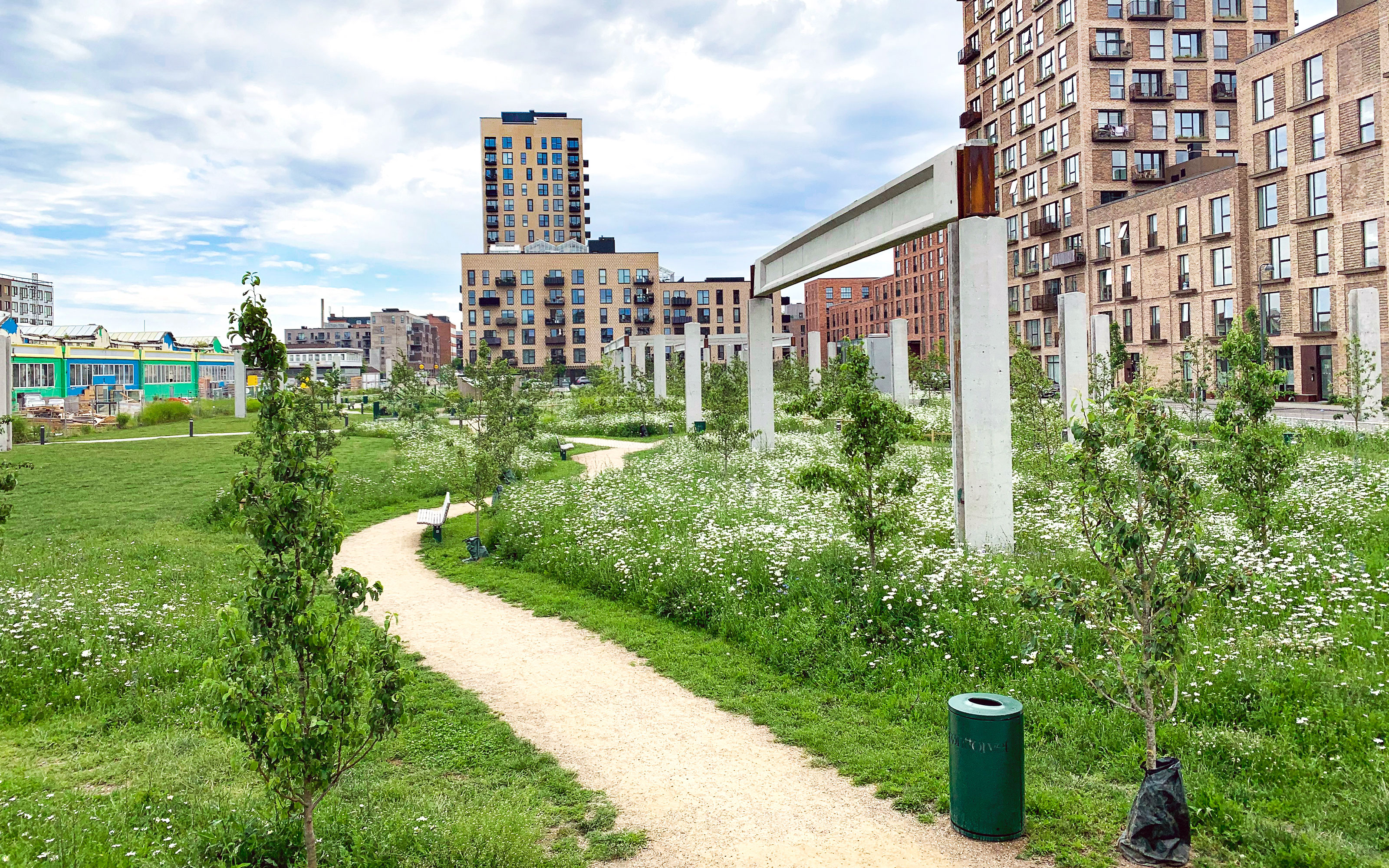 The promenade connects the park to the adjacent properties.  A winding path through meadows with small trees